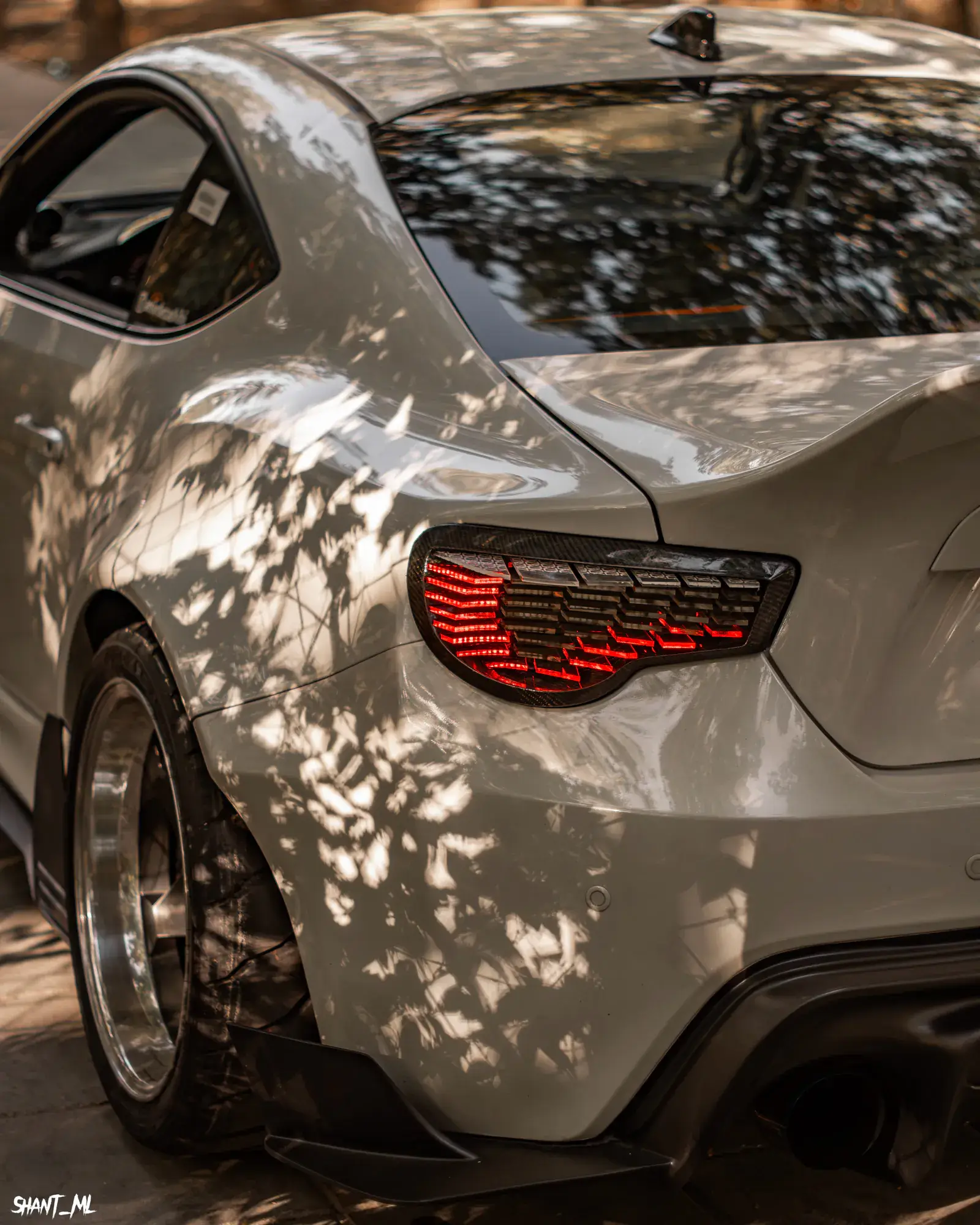 Rear three-quarter view of NYX with the taillight lit