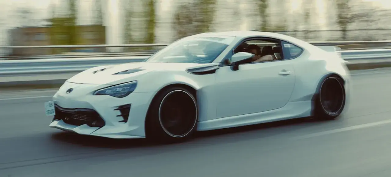 NYX driving on a motorway, front three-quarter view