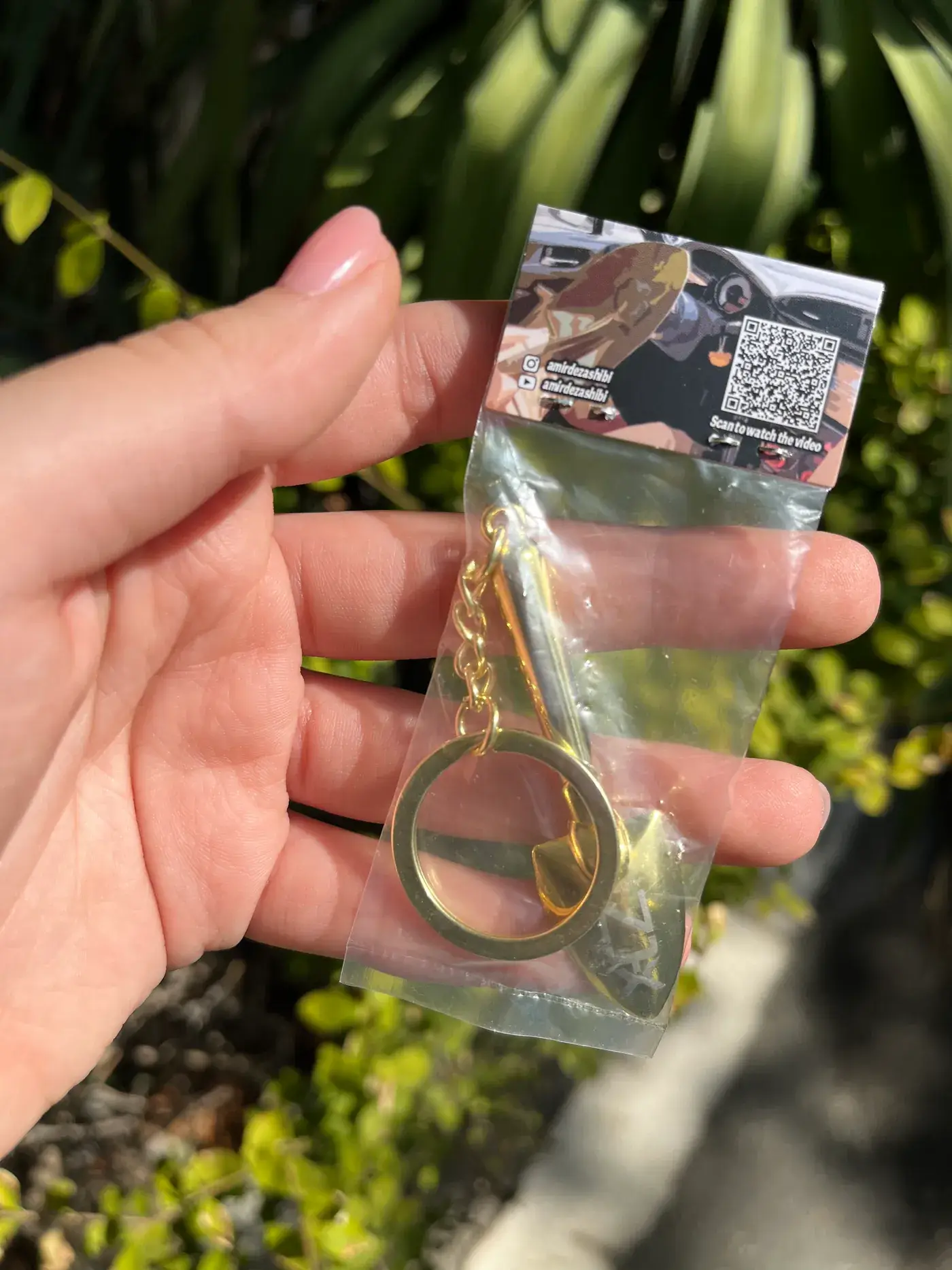 Gold shovel keychain held in hand