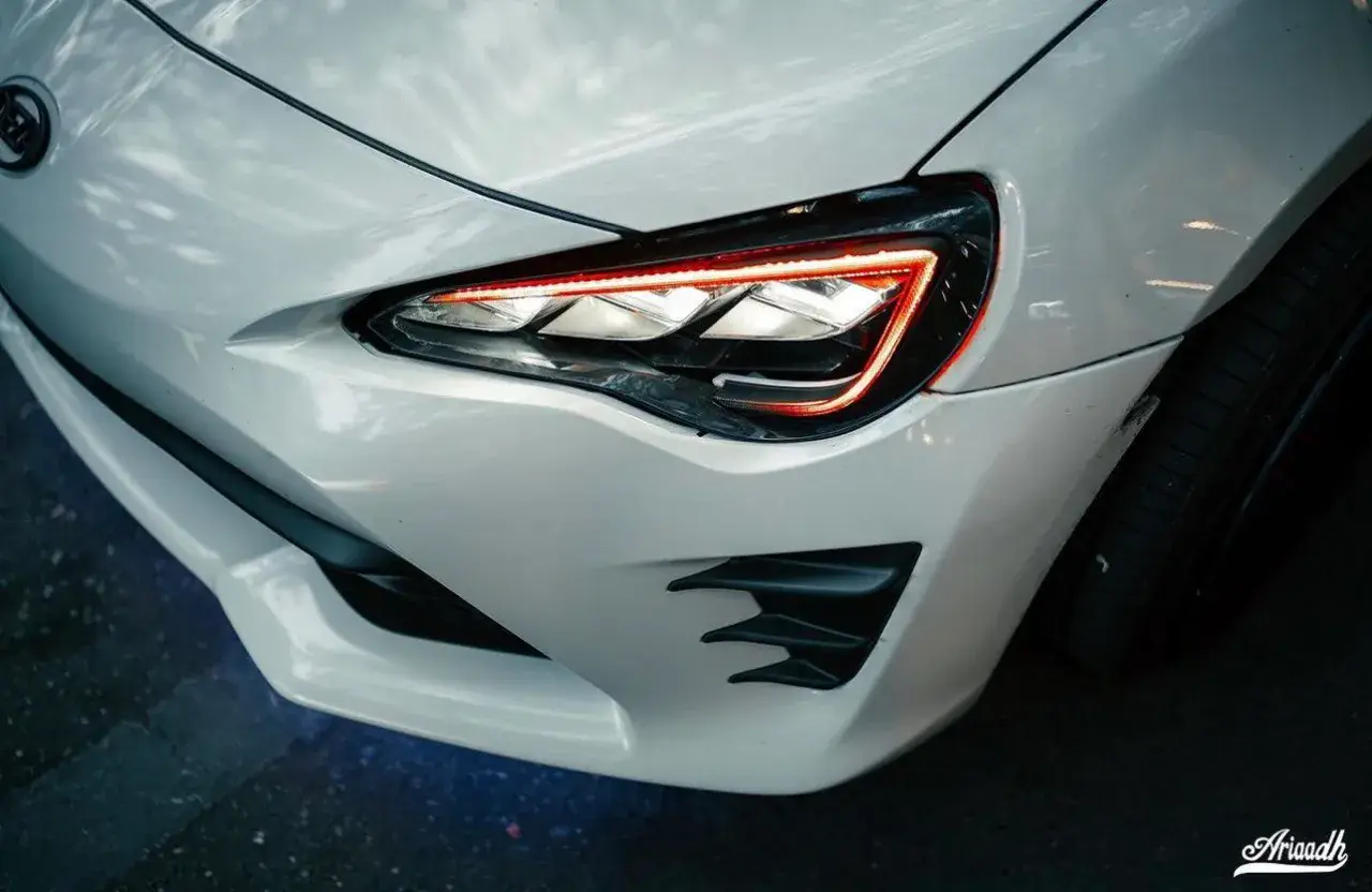 Triple-lens headlight lit up at night