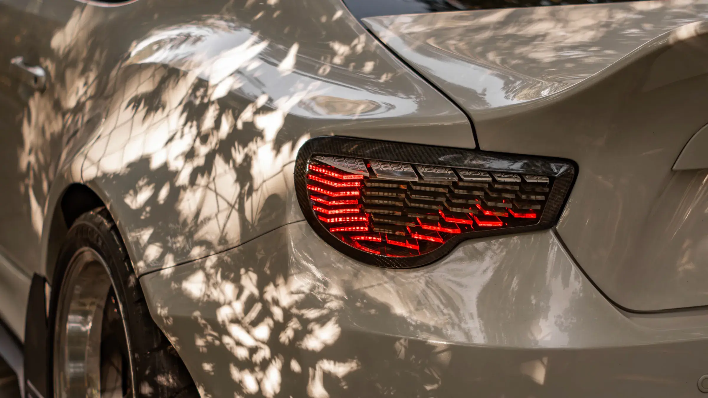 NYX smart taillight glowing red in dappled sunlight